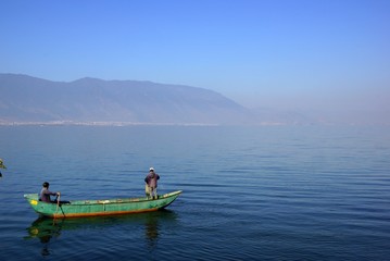 Fototapeta na wymiar People fishing on Erhai lake, Dali, Yunnan province, China