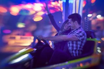 Deurstickers Couple having fun in bumper car © luckybusiness