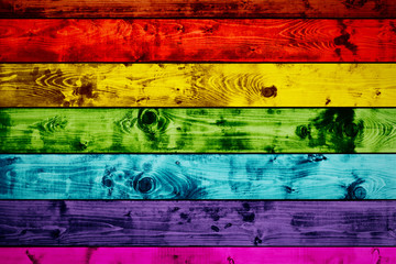 Grunge colorful wood planks background in rainbow colors.