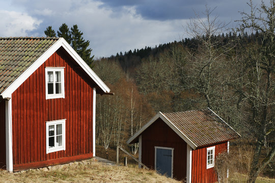 Old Red Cottages In A Rural Landscape Surrounding