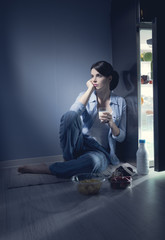 Sleepless woman having a glass of milk