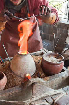 Glass artist in his workshop: making glass beads