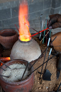 Glass artist in his workshop: making glass beads