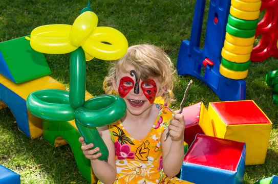 child with face painting - Powered by Adobe
