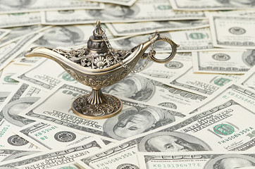 aladdin lamp on dollar background