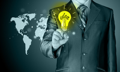 Business man touching light of idea