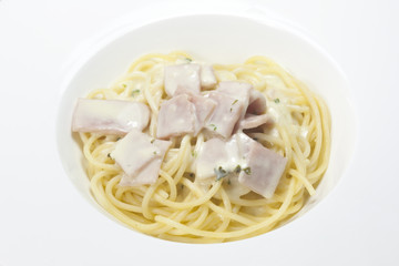 spaghetti with cream sauce on a white background.