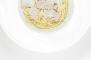 spaghetti with cream sauce top view on a white background.