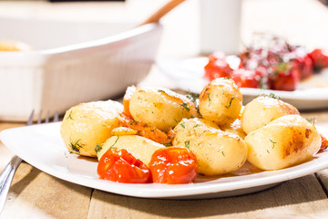 Roasted potatoes with carrot and tomatoes