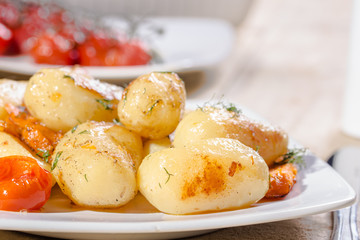 Roasted potatoes with carrot and tomatoes