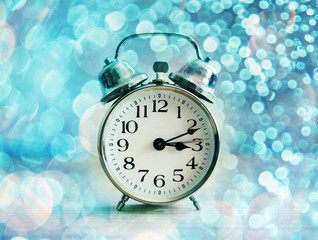 vintage alarm clock with bokeh lights