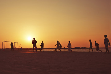 Football at  beach in Dubai during sunset.