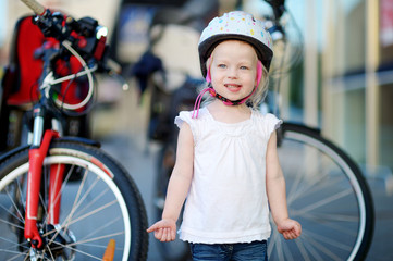 Little toddler girl ready to ride a bike