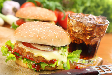 Homemade hamburger with fresh vegetables and cheese on wooden cu