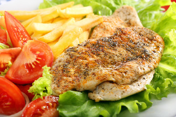 Chicken grilled fillet in herbs with fresh vegetable and fries