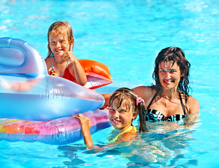 Family in swimming pool.