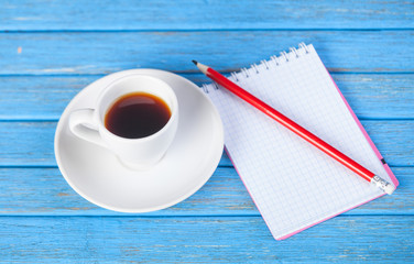 Cup of coffee and notebook.