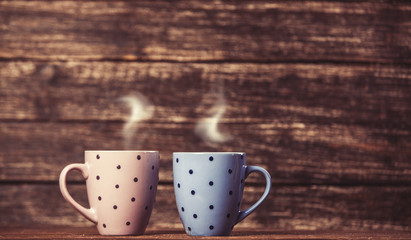 Two tea or coffee cup on wooden table.