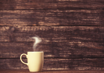 Tea or coffee cup on wooden table.