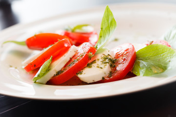 Tomato and mozzarella with basil leaves
