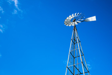 .Looking Up at Tall Metal Water Pumping Windmill