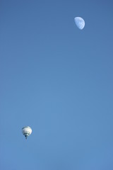 Ballon and moon in a blue sky