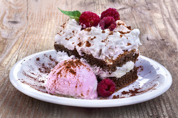 Fototapeta na wymiar Sweet summer cake with ice cream and raspberries