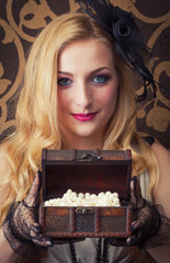 beautiful retro woman opeing a chest with jewelry