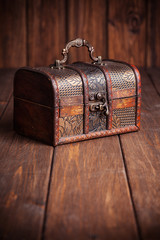closed treasure chest standing on wooden table
