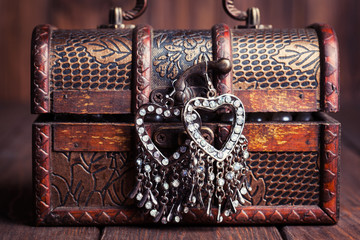 vintage earrings in a form of hearts hanging on old treasure che