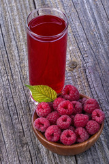 Juice of healthy organic raspberries on old rustic table