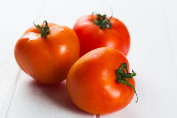 tomatoes on white wooden table