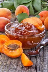 Healthy domestic apricot jam on old rustic table