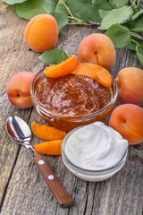 domestic apricot jam with sour cream on old rustic table