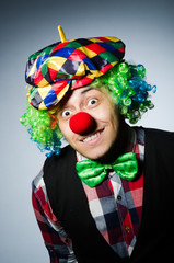 Funny clown against the dark background