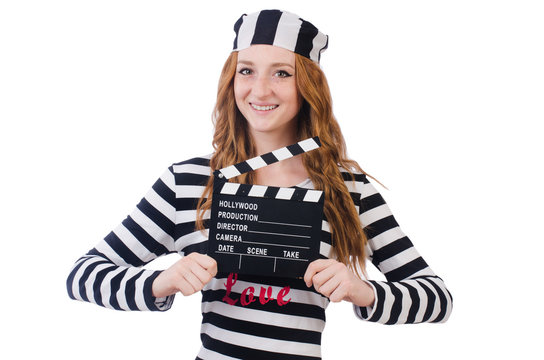 Young woman-prisoner with movie board isolated on white