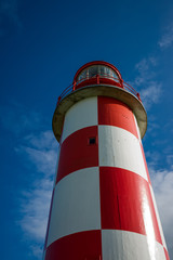 Looking up at Towering Red and White Lighthouse