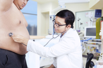 Doctor is checking a fat patient 1