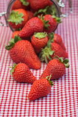 Tasty fresh strawberries in glass storage jar