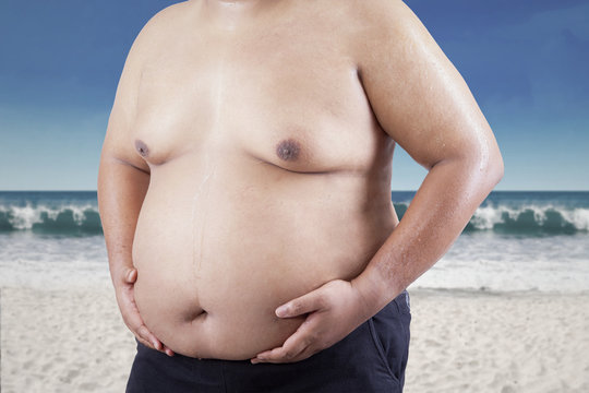 Fat Man Holding His Stomach At Beach 1