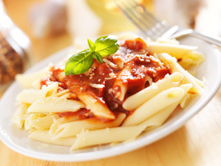plate of italian penne pasta in tomato sauce