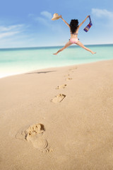 Fototapeta na wymiar Footprints and excited woman jumping