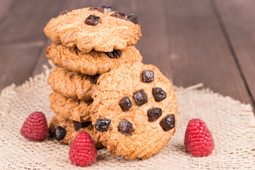 Chocolate chips cookies over a wooden background