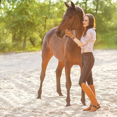 Beautiful woman and horse. Backlight.