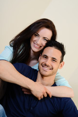 happy beautiful young couple relaxing sofa together home