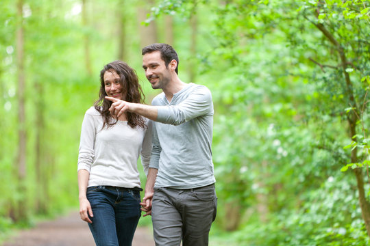 Young couple having a walk in a forest