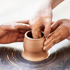 Female Potter creating a bowl on a Potters wheel