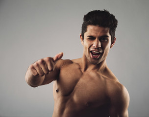 Fototapeta premium Happy masculine man showing thumbs up sign