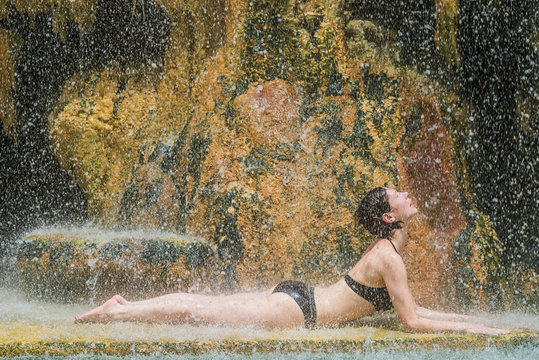 one woman bathing ma'in hot springs waterfall Jordan