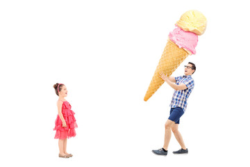 Man bringing huge ice cream to excited girl
